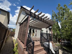 Deck staining Calgary project showing restained deck, privacy screen and pergola by Fix On Call