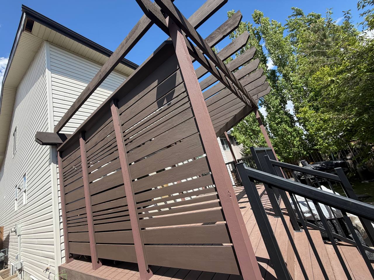 Deck and fence privacy screen staining in Calgary with pergola structure by Fix On Call
