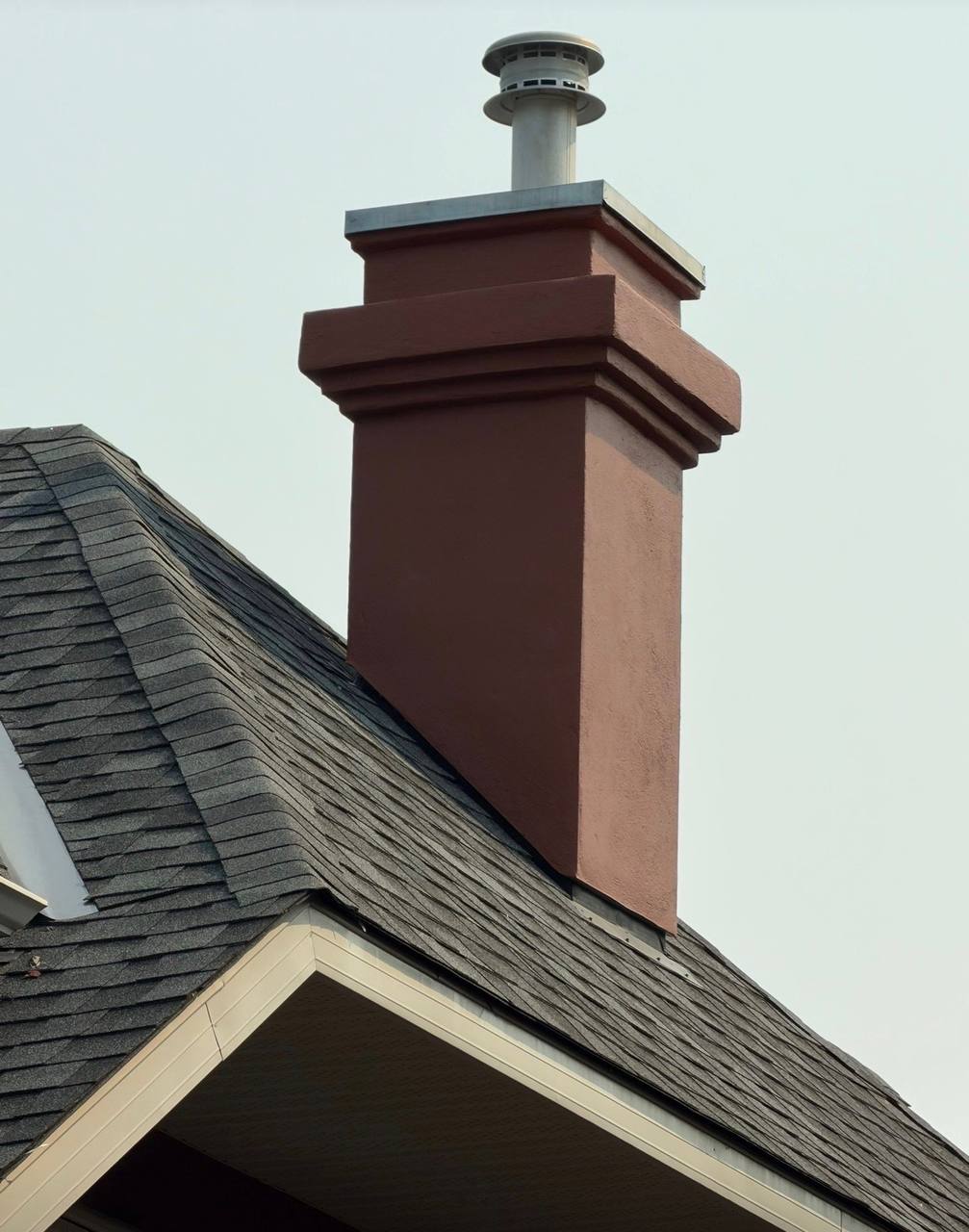 Completed Calgary chimney stucco repair with rebuilt decorative details