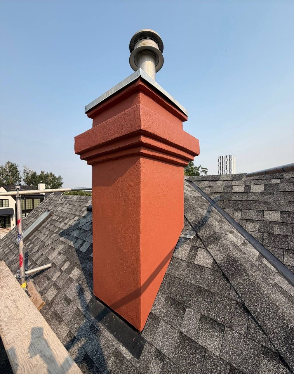 Finished chimney stucco repair with restored profile on a Calgary home