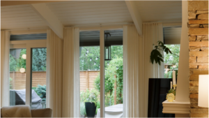 Fresh white-painted ceiling and trim beside a natural stone fireplace wall.