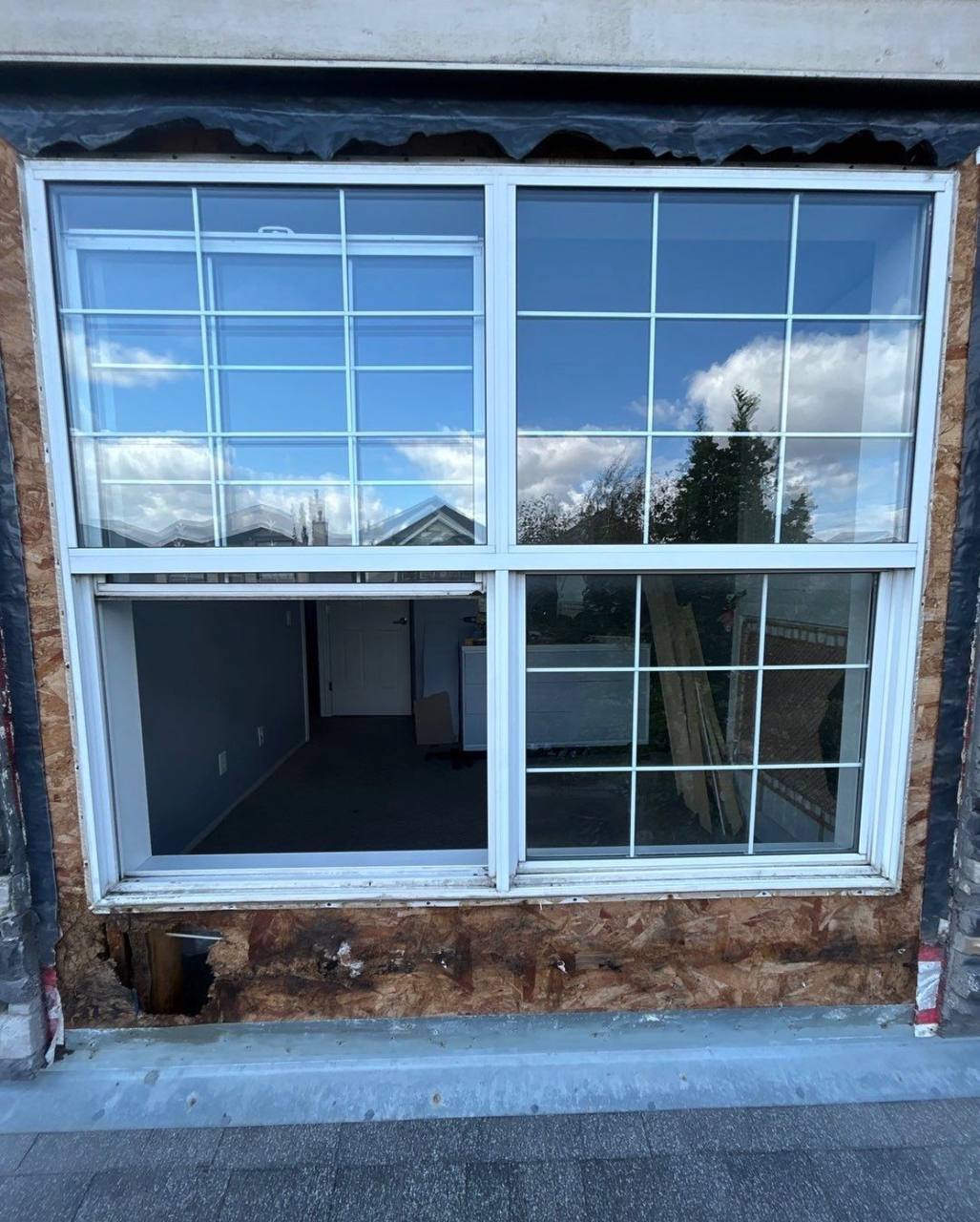 Existing window with an exposed wall area before replacement