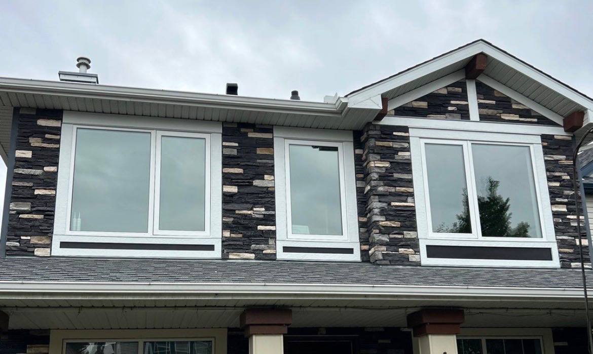 Finished exterior with replacement windows and a new dark panel design