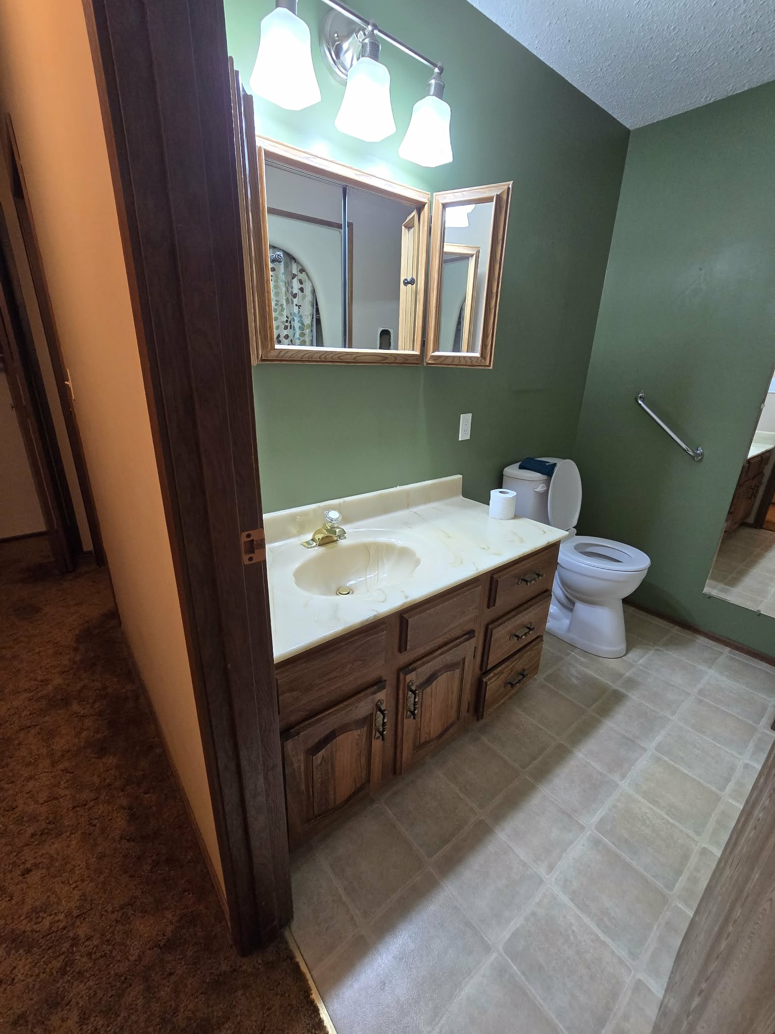 Original bathroom countertop and wood vanity before the countertop update
