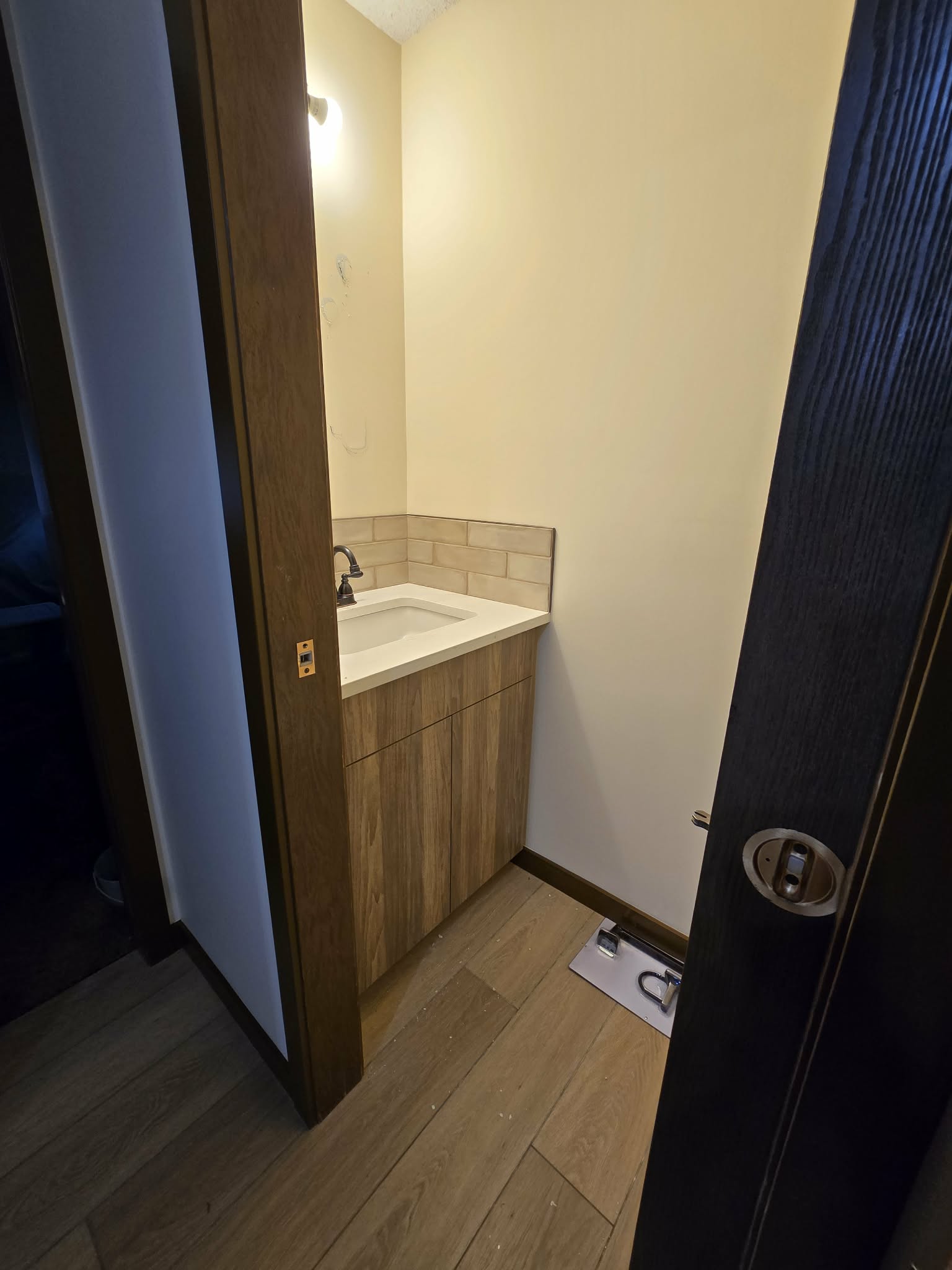 Powder-room countertop, integrated sink, faucet and backsplash during installation progress